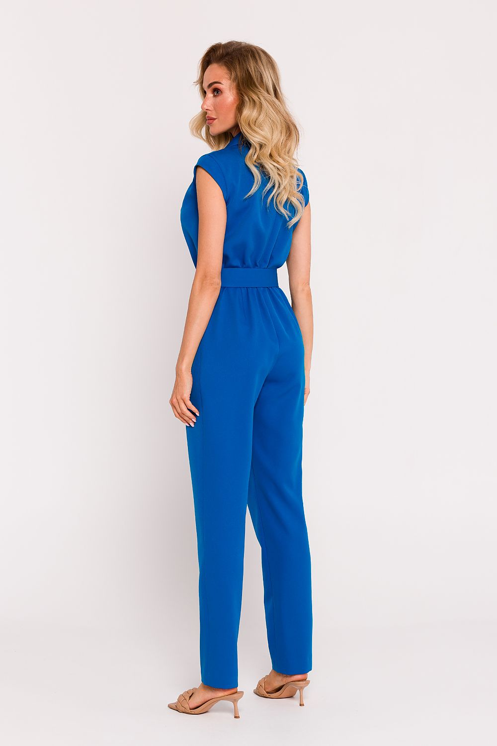 Woman wearing a blue jumpsuit on a white background