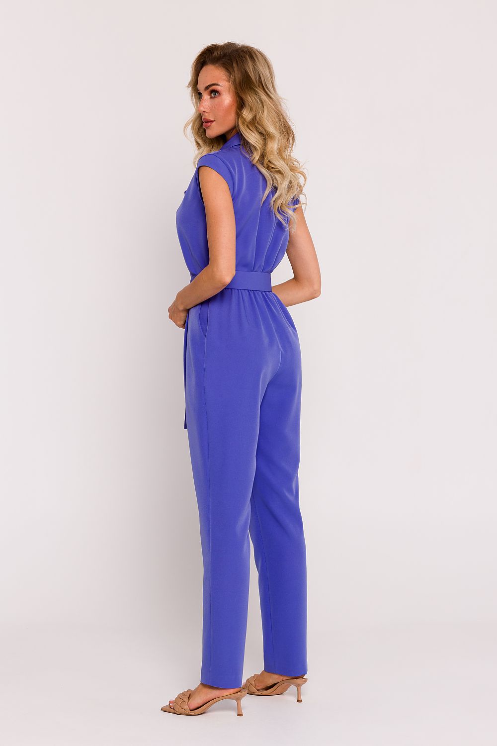 Woman wearing a blue jumpsuit on a white background