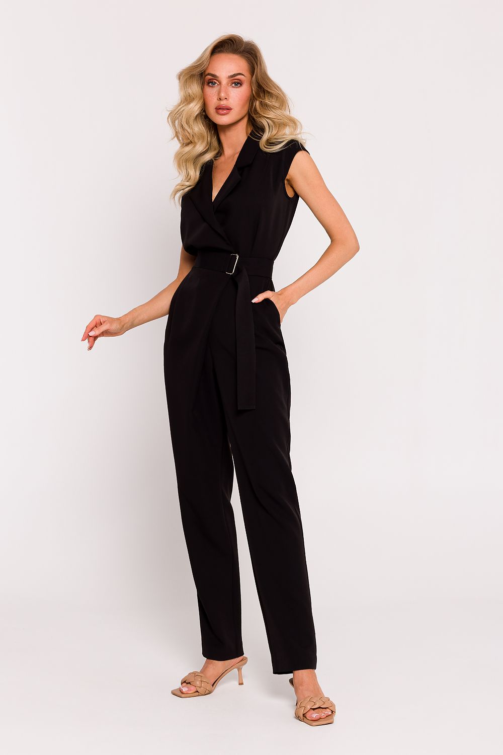Woman wearing a black jumpsuit on a white background