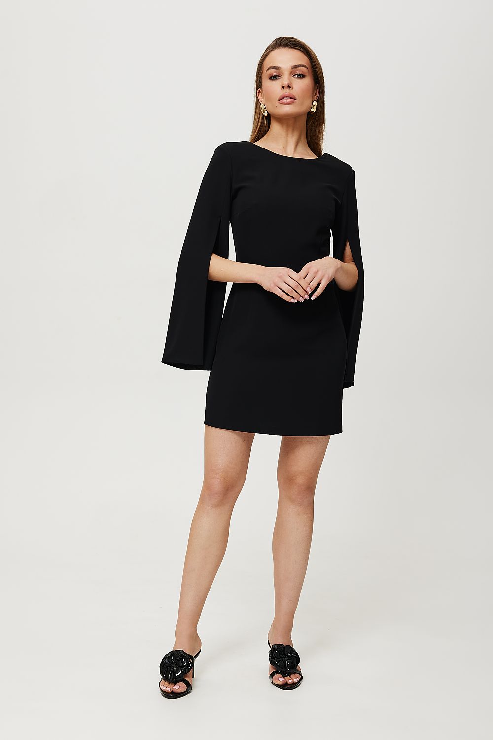Woman wearing a black dress on a white background