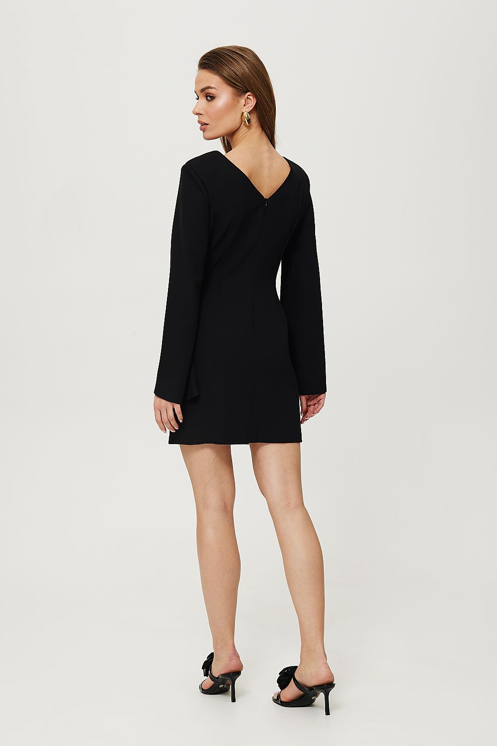 Woman wearing a black dress on a white background