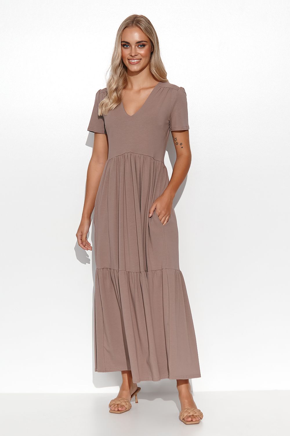 Woman wearing a brown dress on a white background