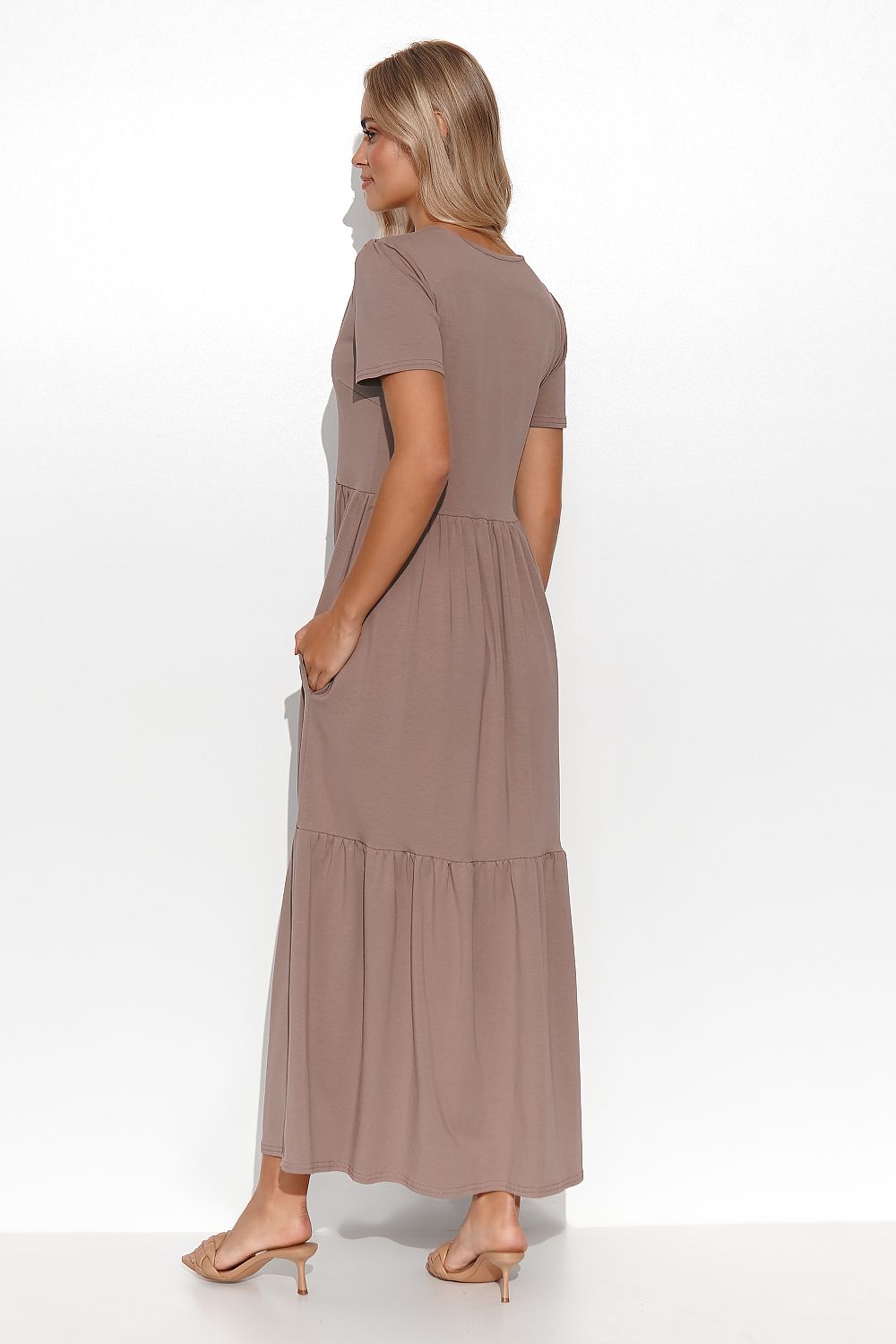 Woman wearing a brown dress on a white background