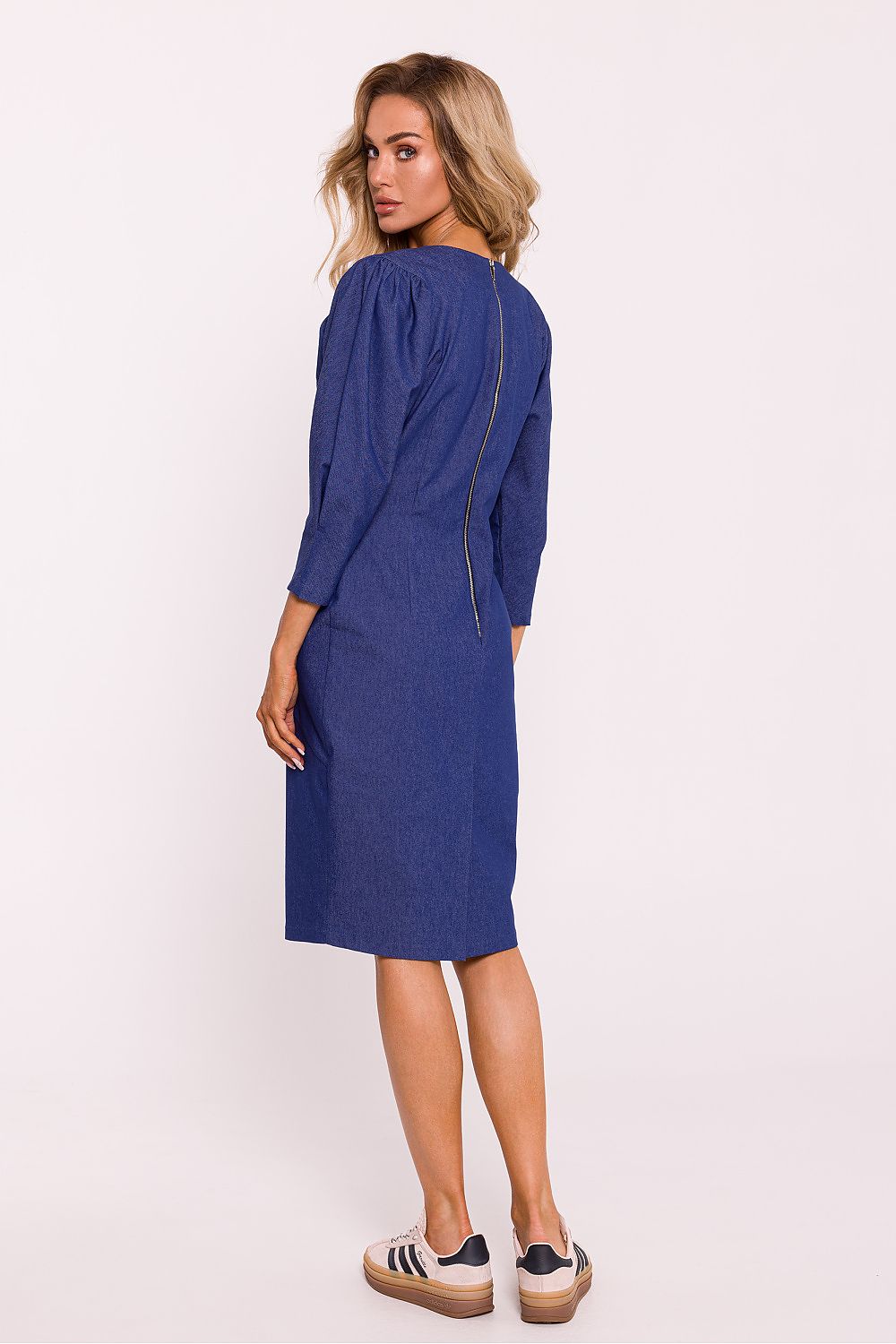 Woman wearing a blue dress on a white background