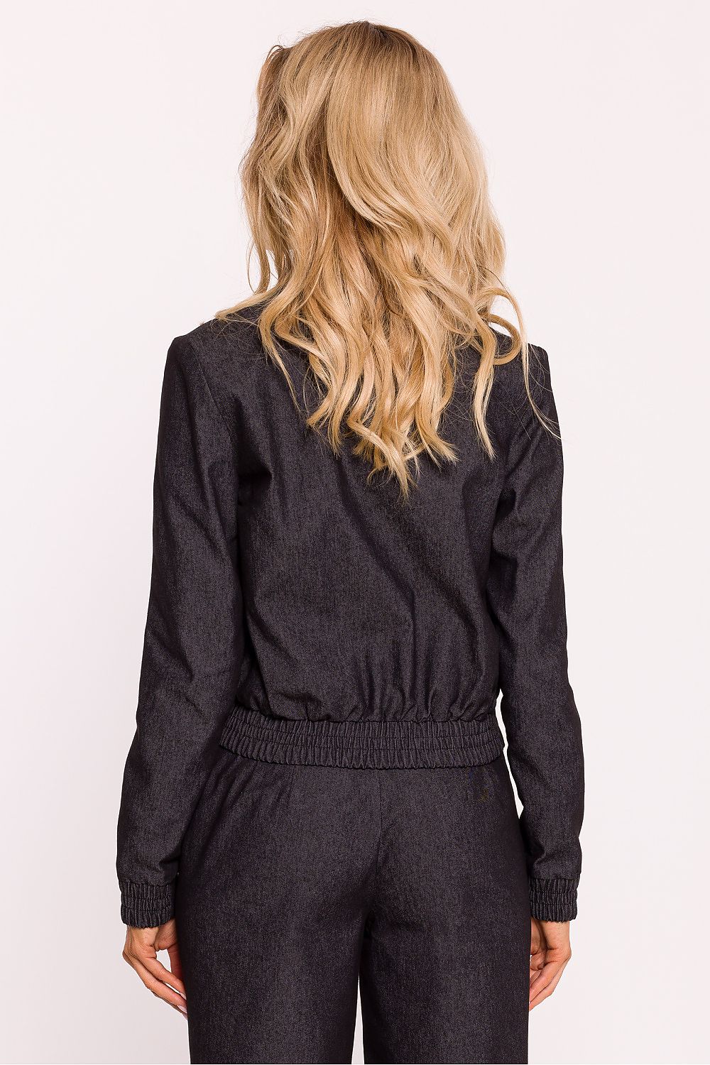 Person wearing a dark gray outfit with long sleeves and pants on a white background