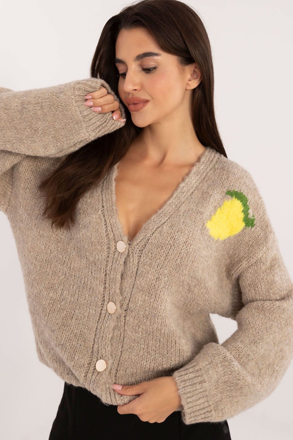 Front view of beige buttoned women’s sweater with V-neck and small print on the chest.