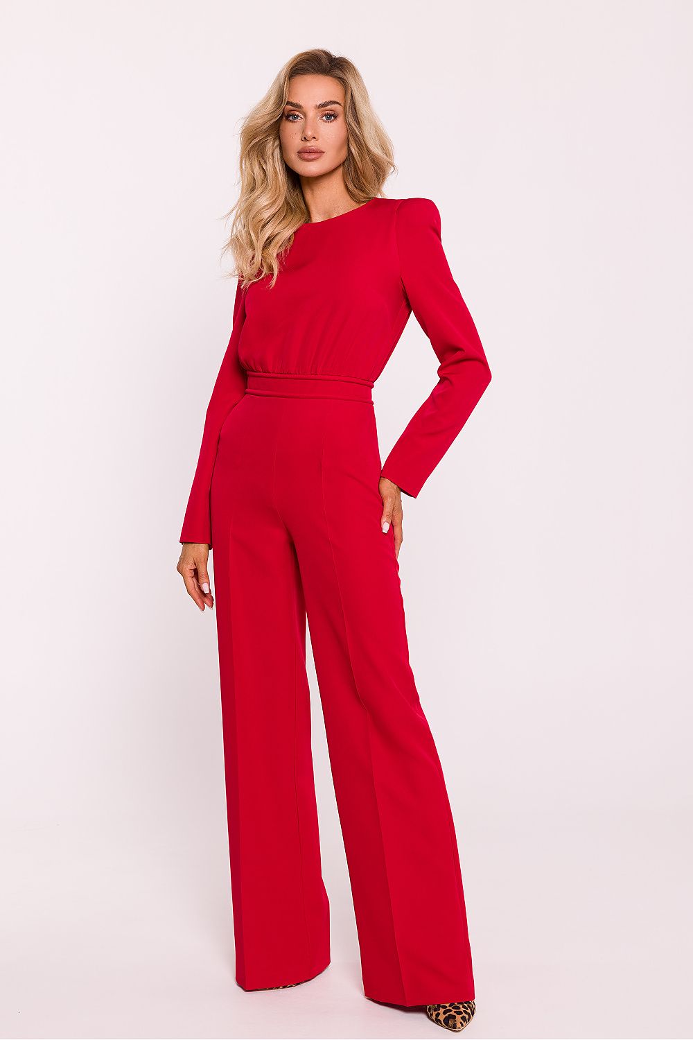 Woman wearing a red jumpsuit on a white background
