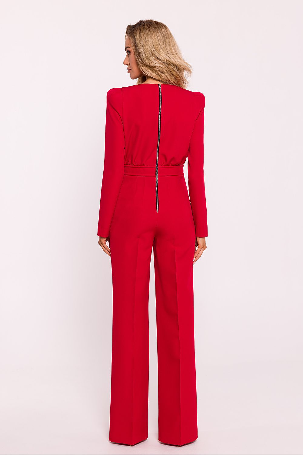 Red jumpsuit worn by a person on a white background