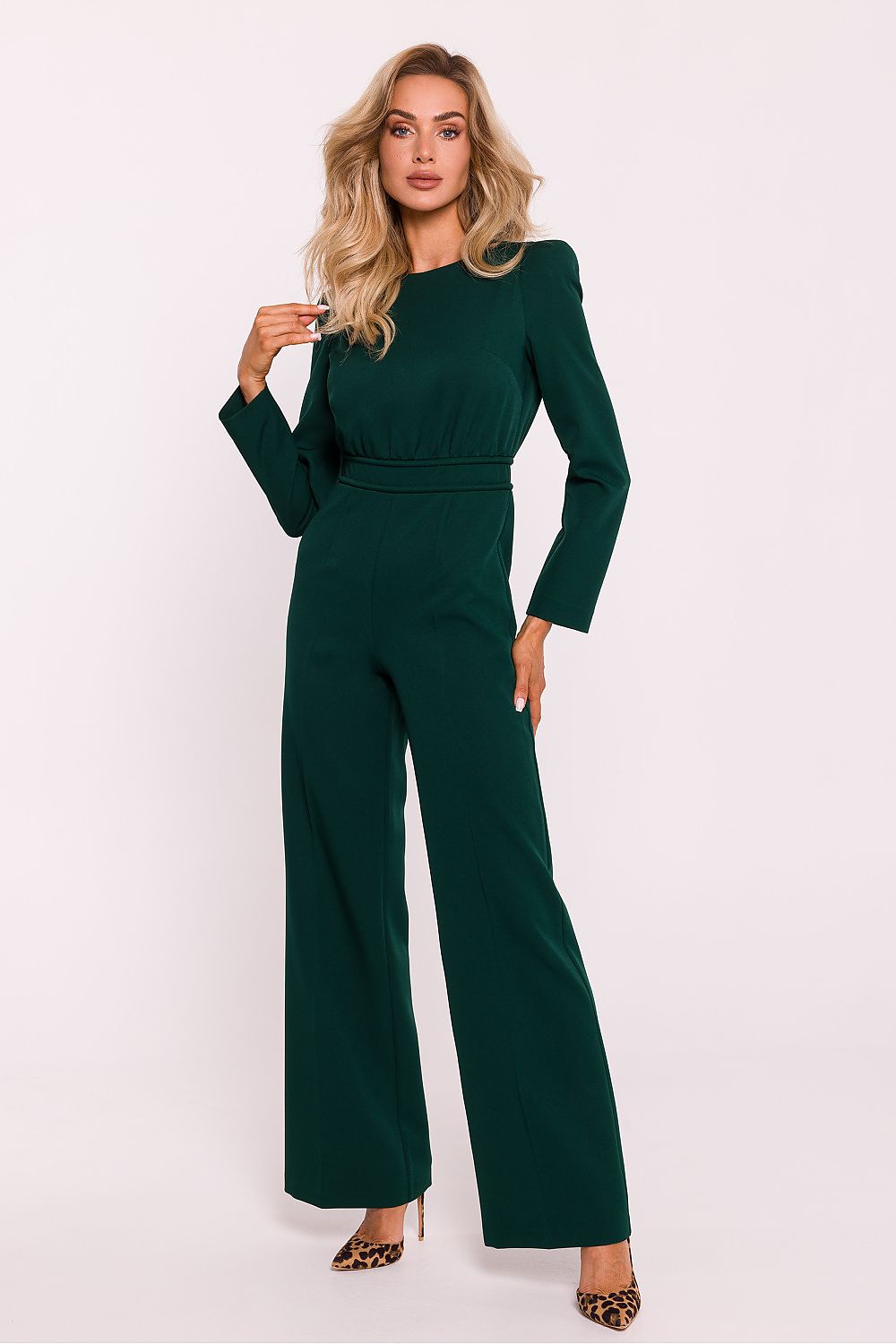 Woman wearing a green jumpsuit on a white background