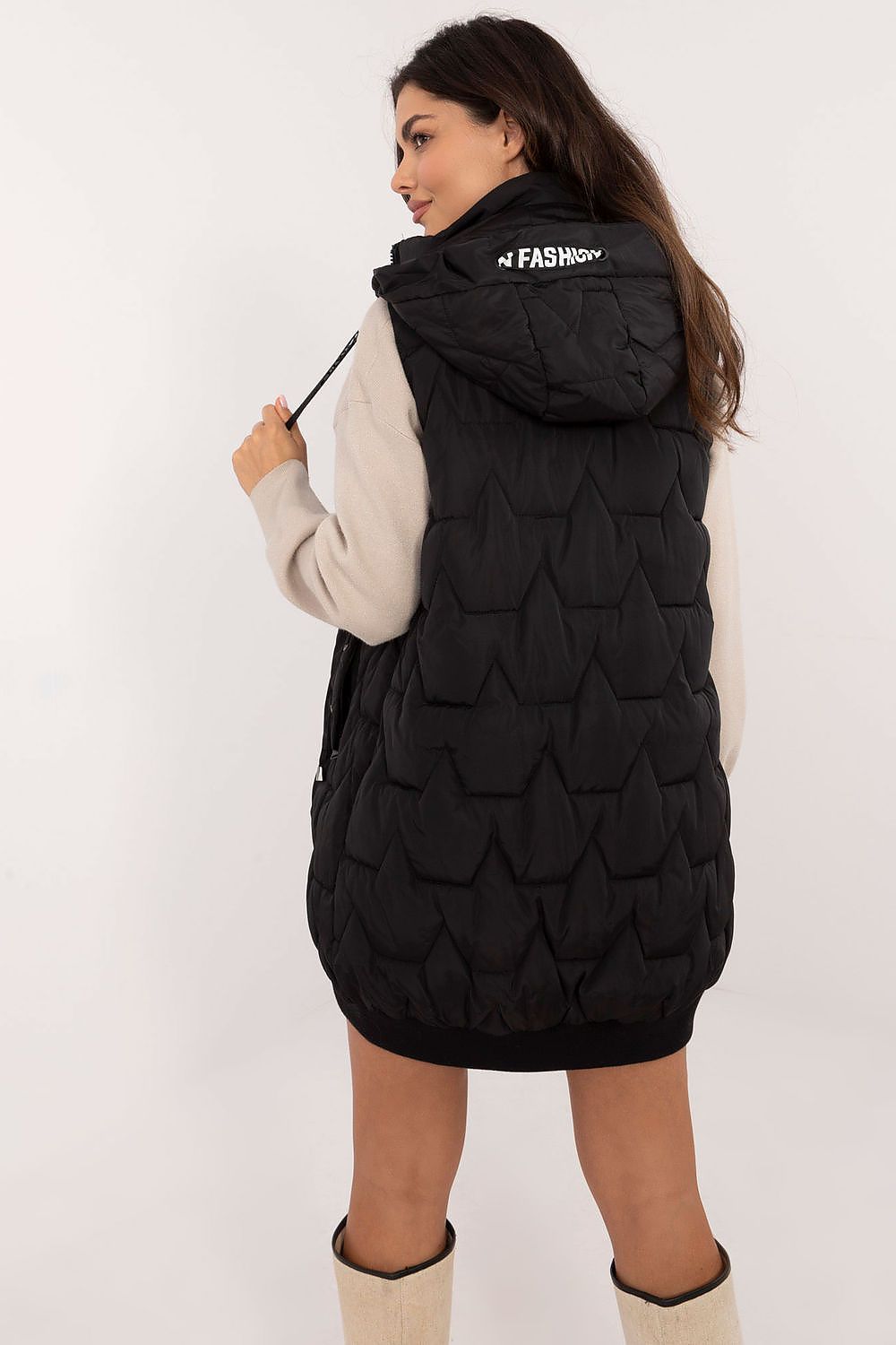  Model in black padded sleeveless jacket, front zip closed.