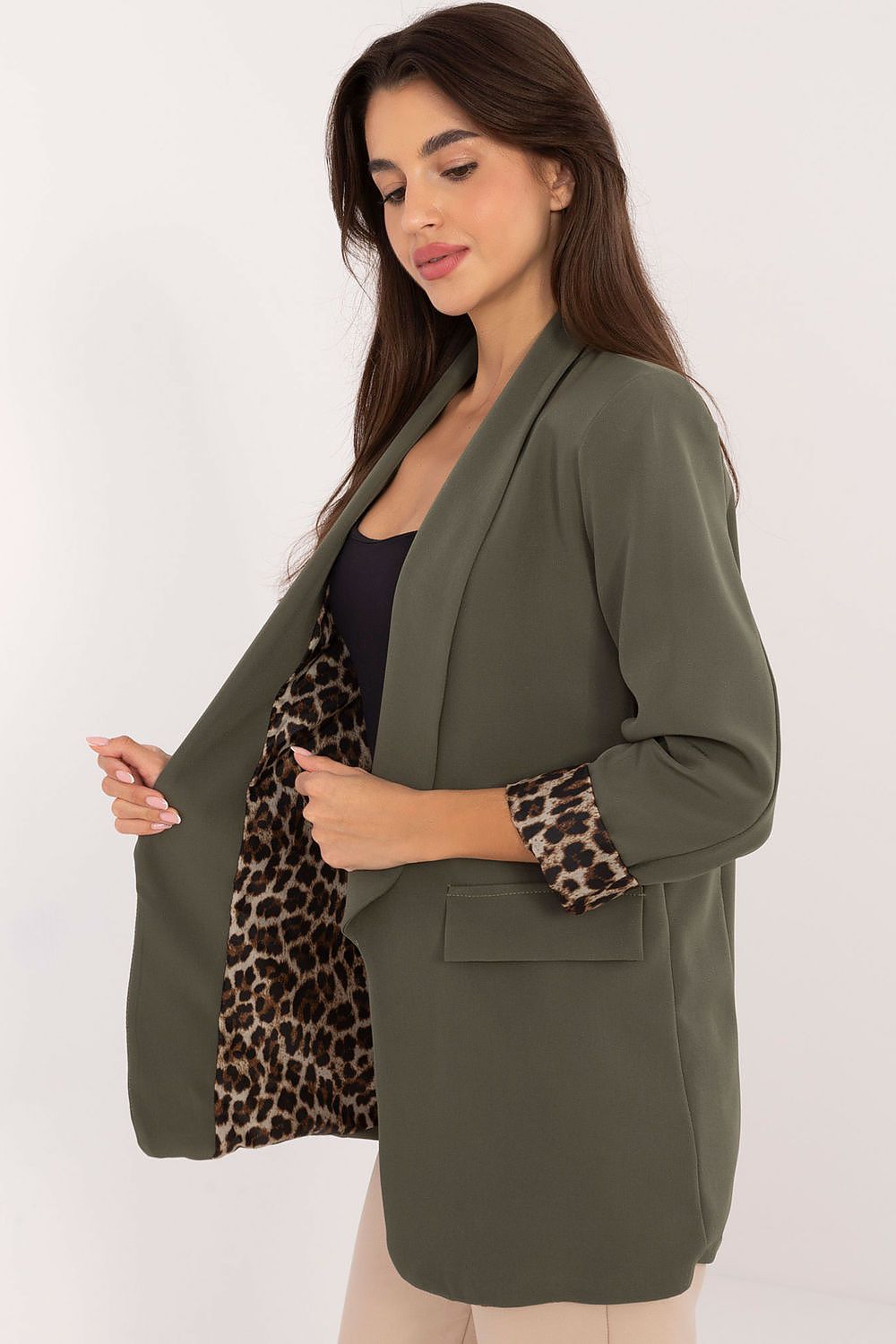 Side view showing modern open-front cut of green Elise jacket.