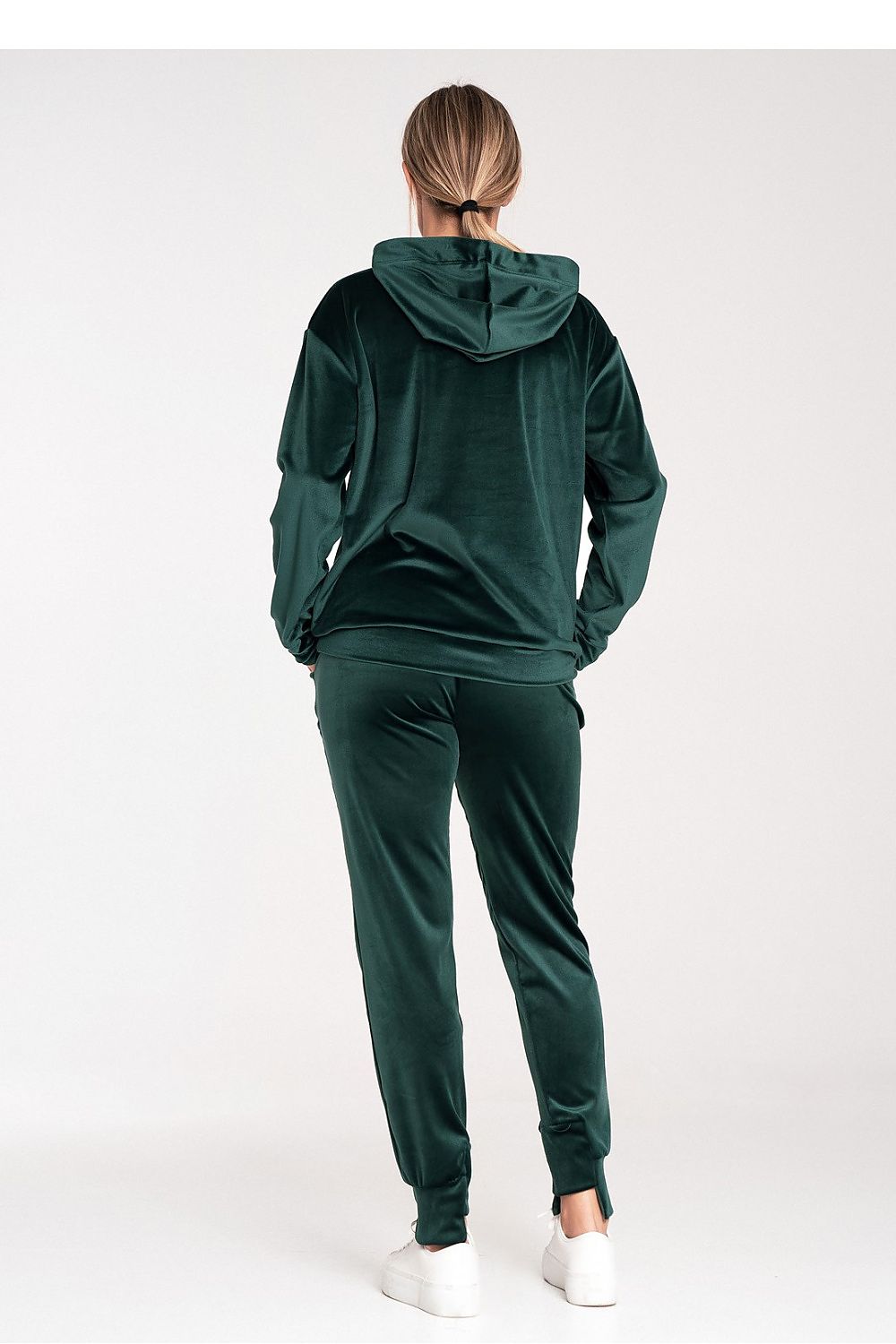 Person wearing a green tracksuit on a white background