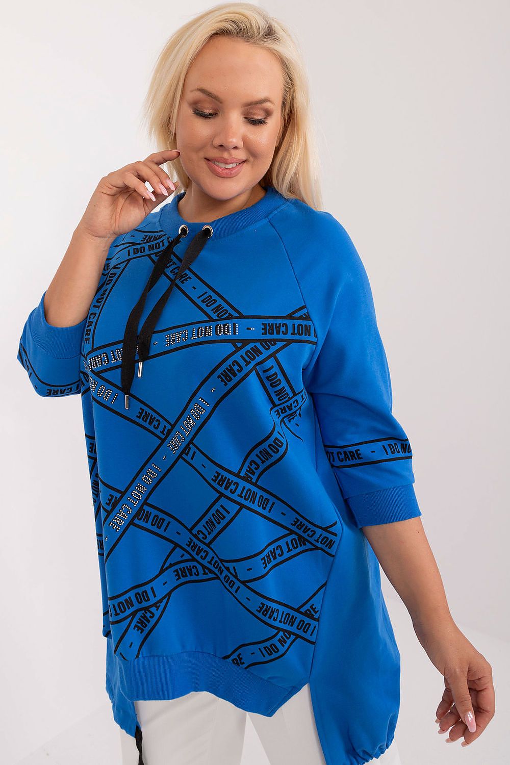 Woman wearing a blue sweatshirt with black text design on a white background