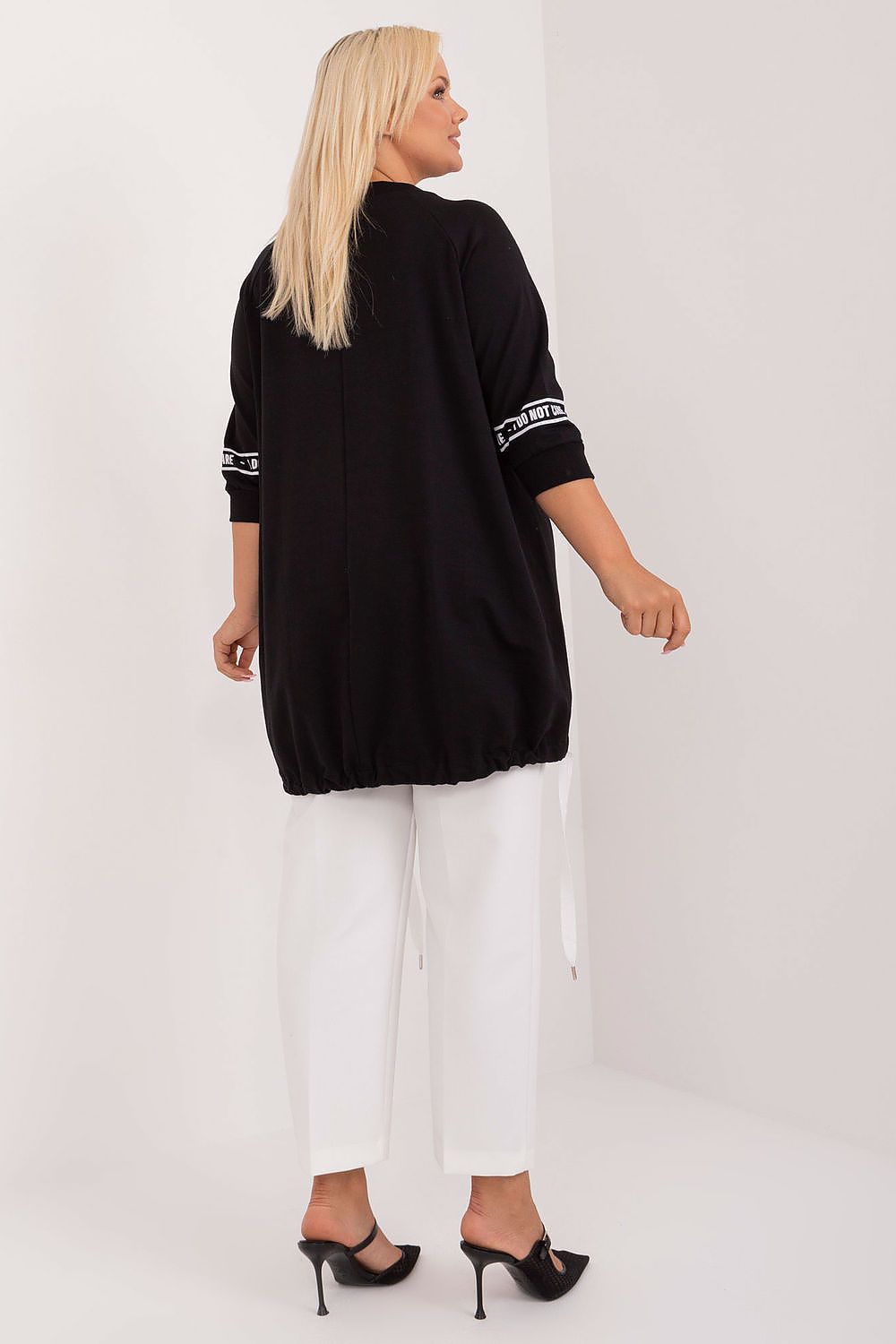  Model wearing black rhinestone top in a classy, casual styling