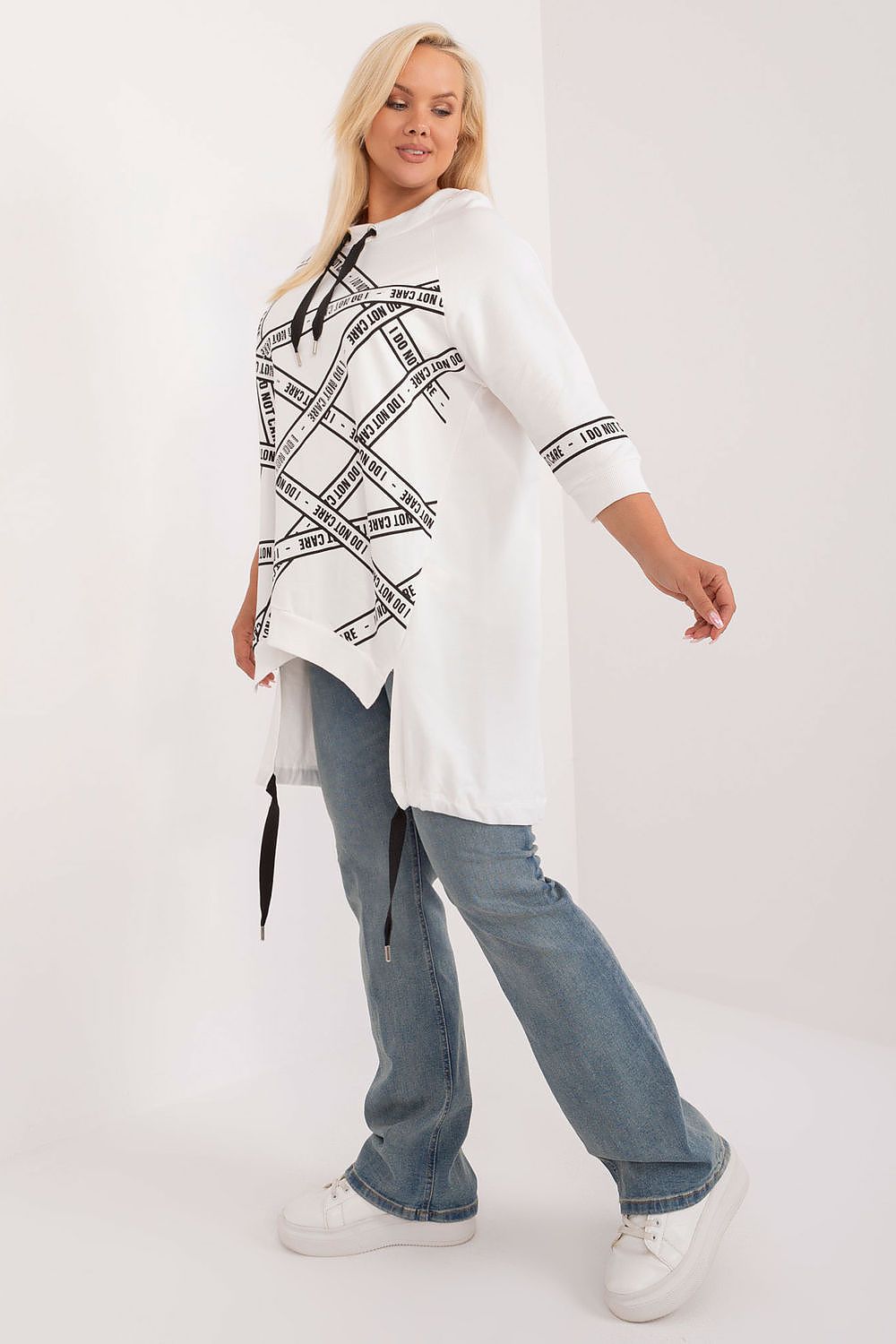  Side view of beige top showing lightweight fabric and 3/4 sleeves