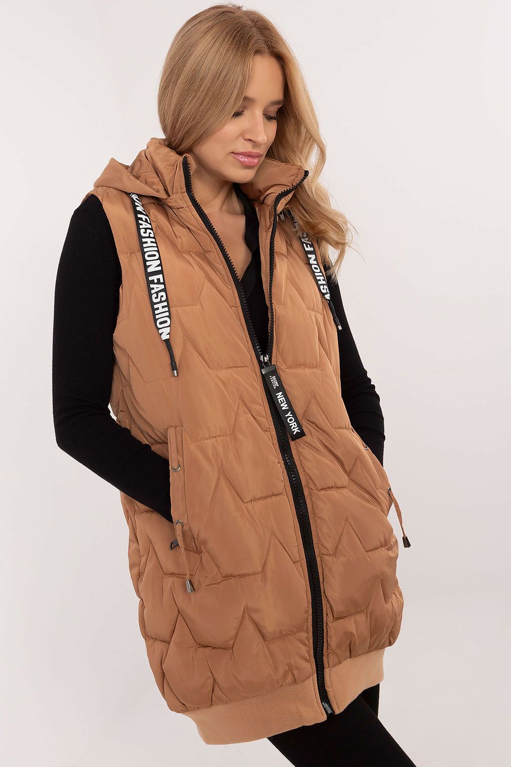 Woman wearing a brown puffer vest with 'New York Fashion' branding on a white background
