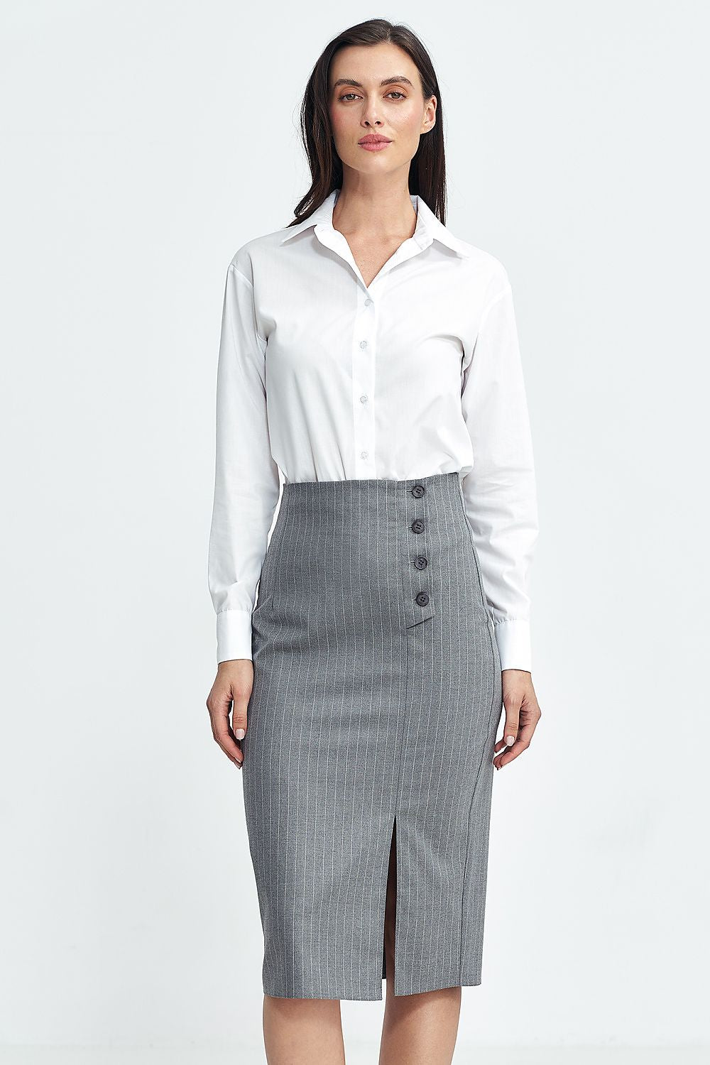 Woman wearing a white shirt and gray skirt on a white background