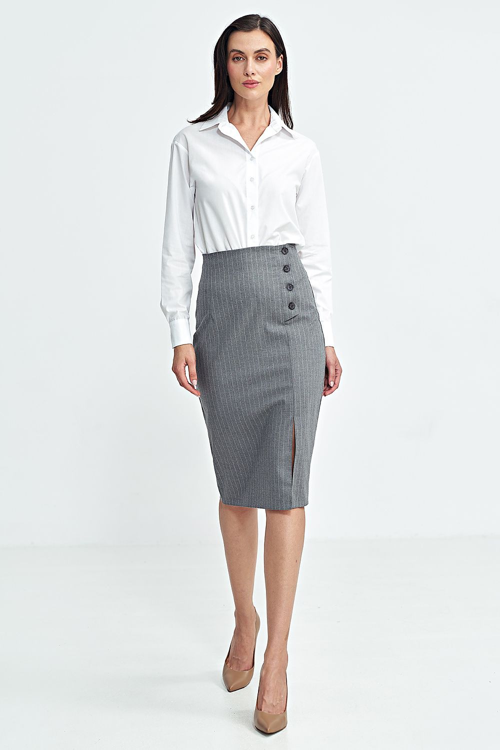 Woman wearing a white blouse and gray skirt on a white background