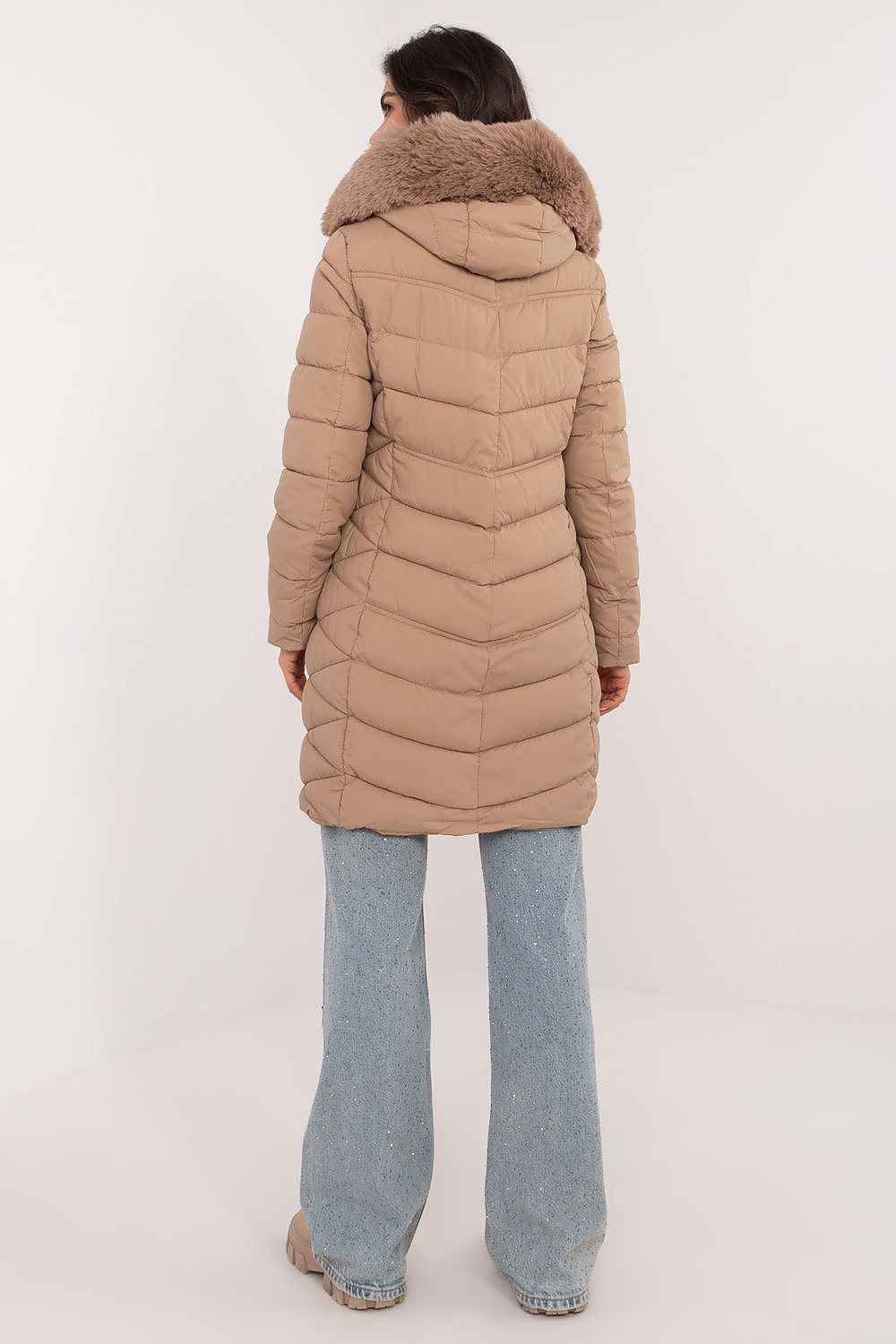 Beige knee-length quilted jacket with faux fur hood. 