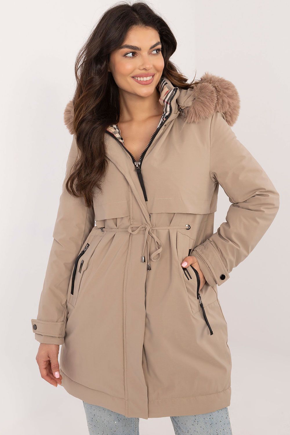 Woman wearing a beige parka with fur hood on a white background
