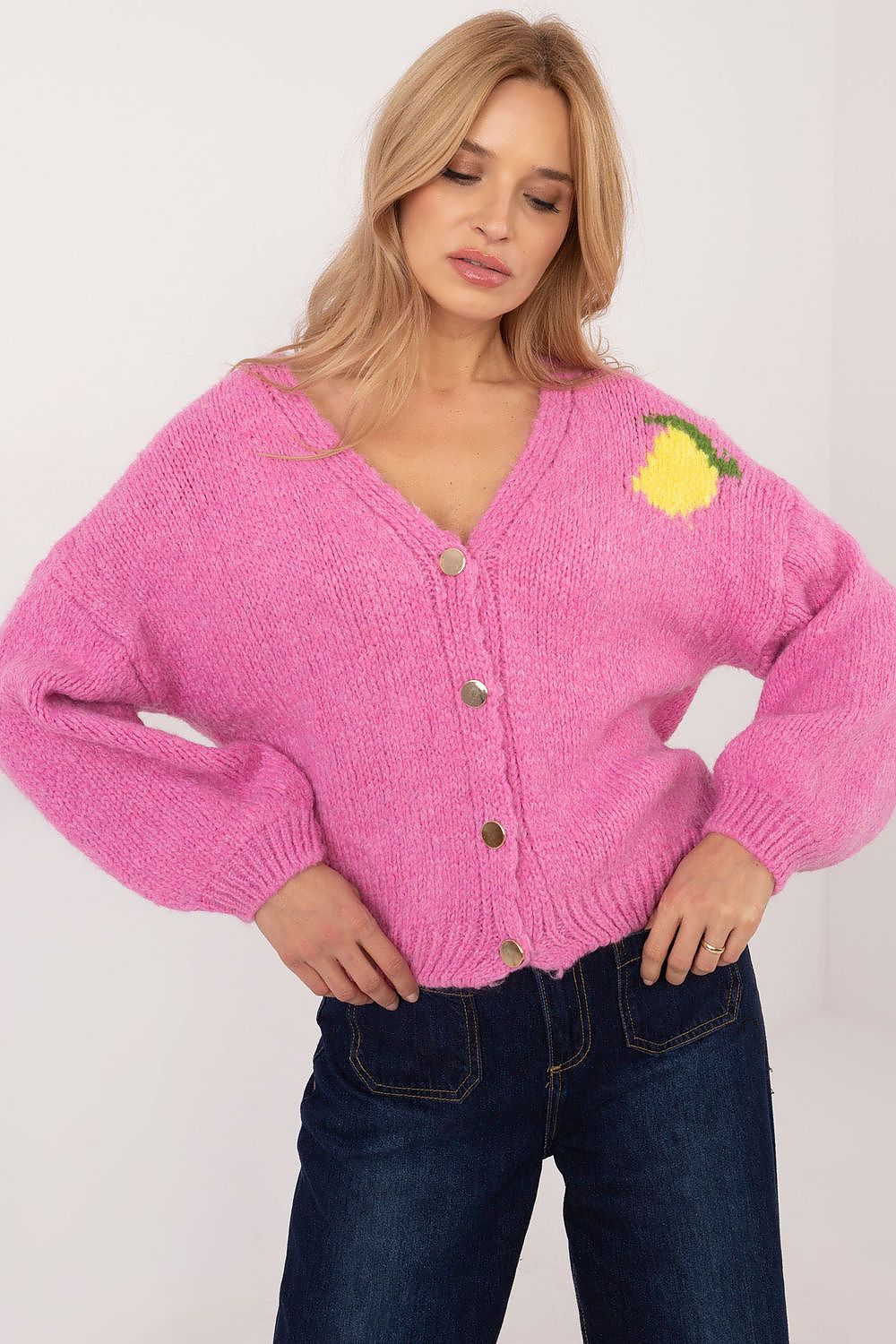 Front view of pink women’s casual sweater with button closure and V-neck.