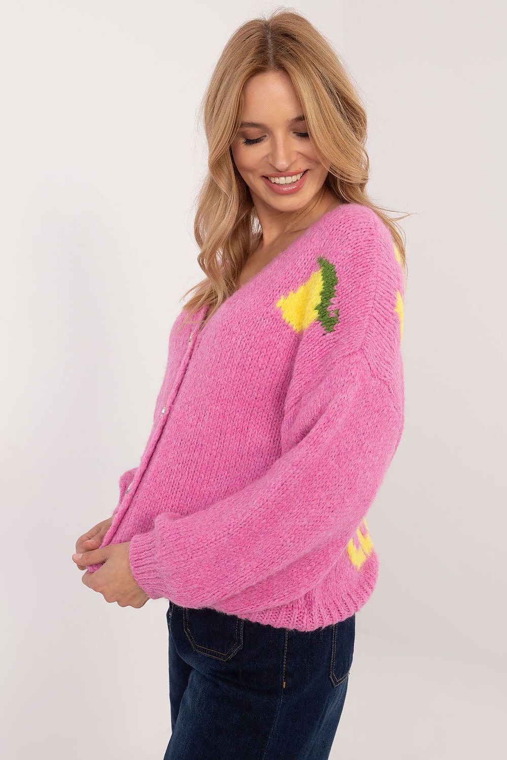 Side angle of pink V-neck sweater showing soft knit blend.