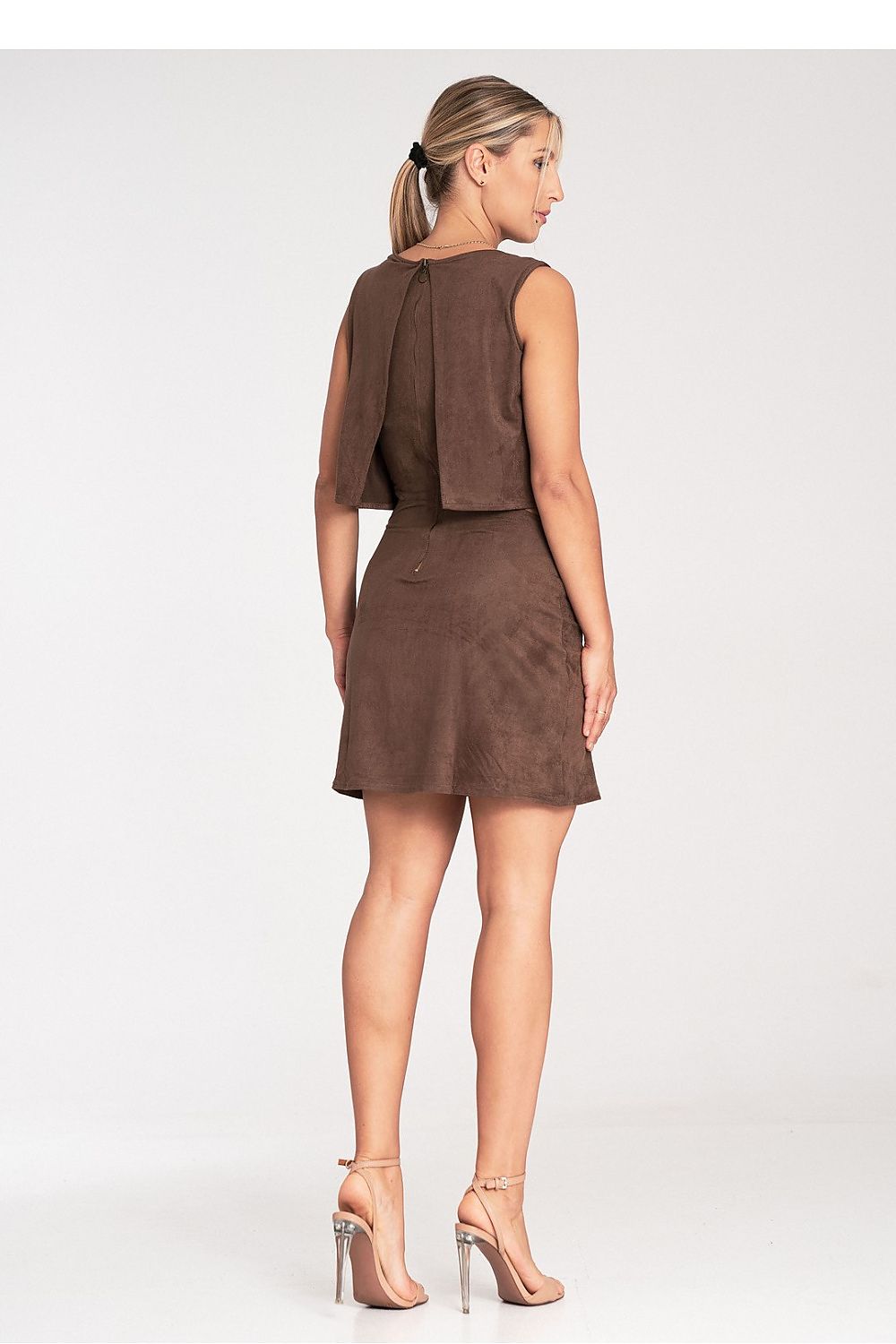 Woman wearing a brown dress on a white background