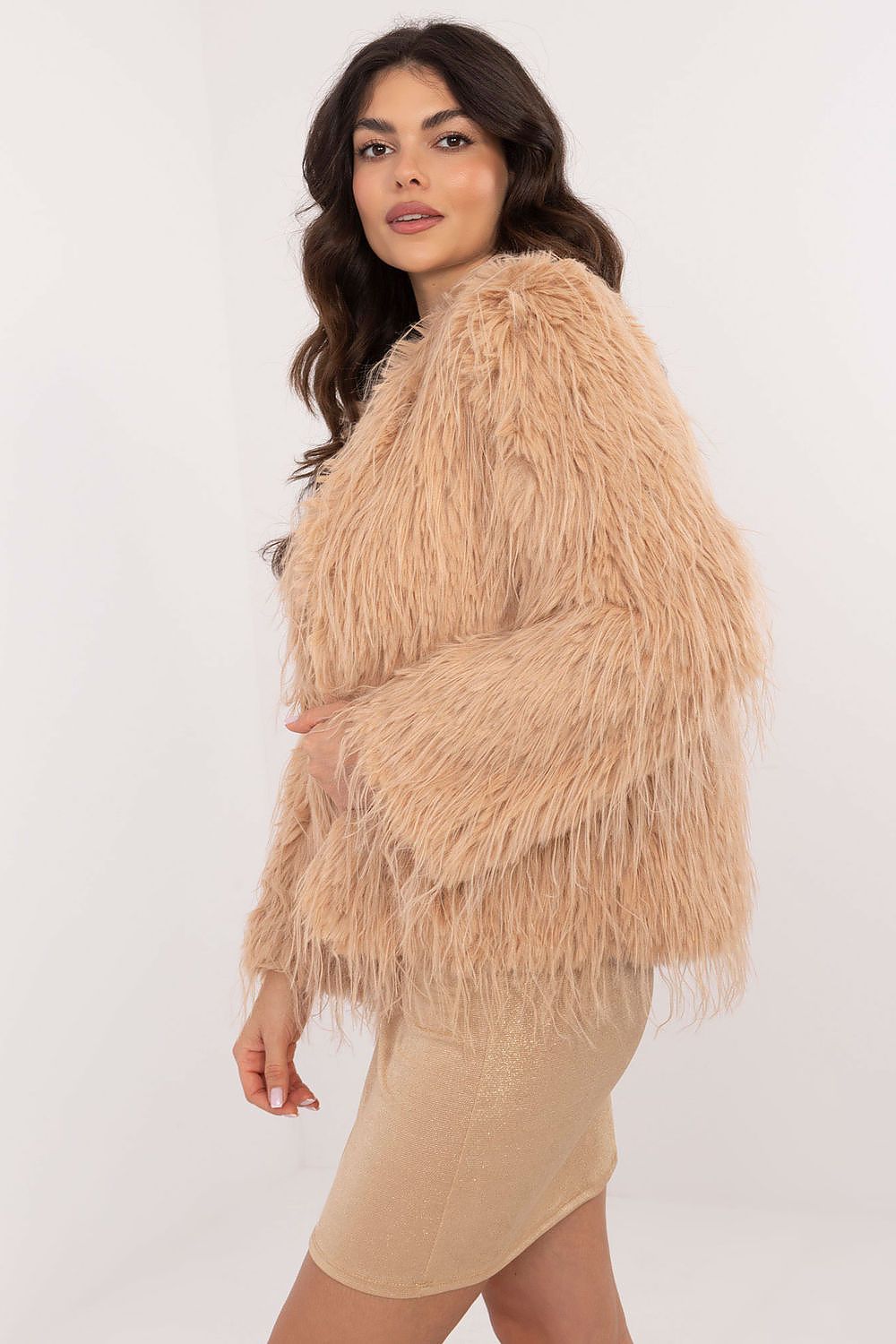 Woman wearing a beige fluffy jacket on a white background