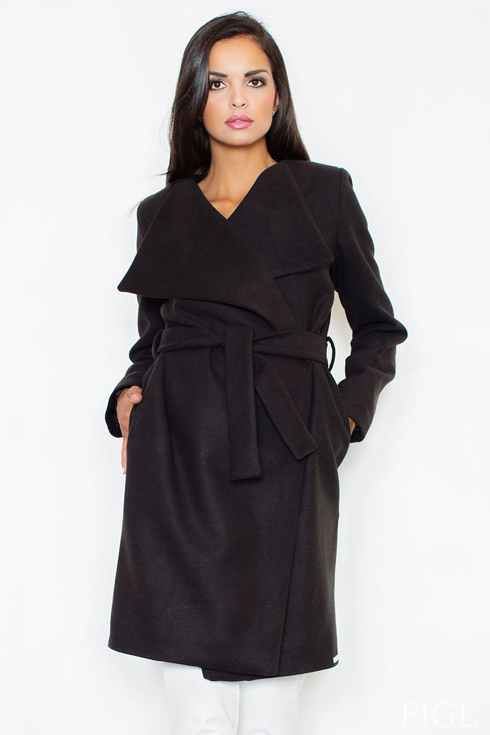 Woman wearing a black coat against a white background