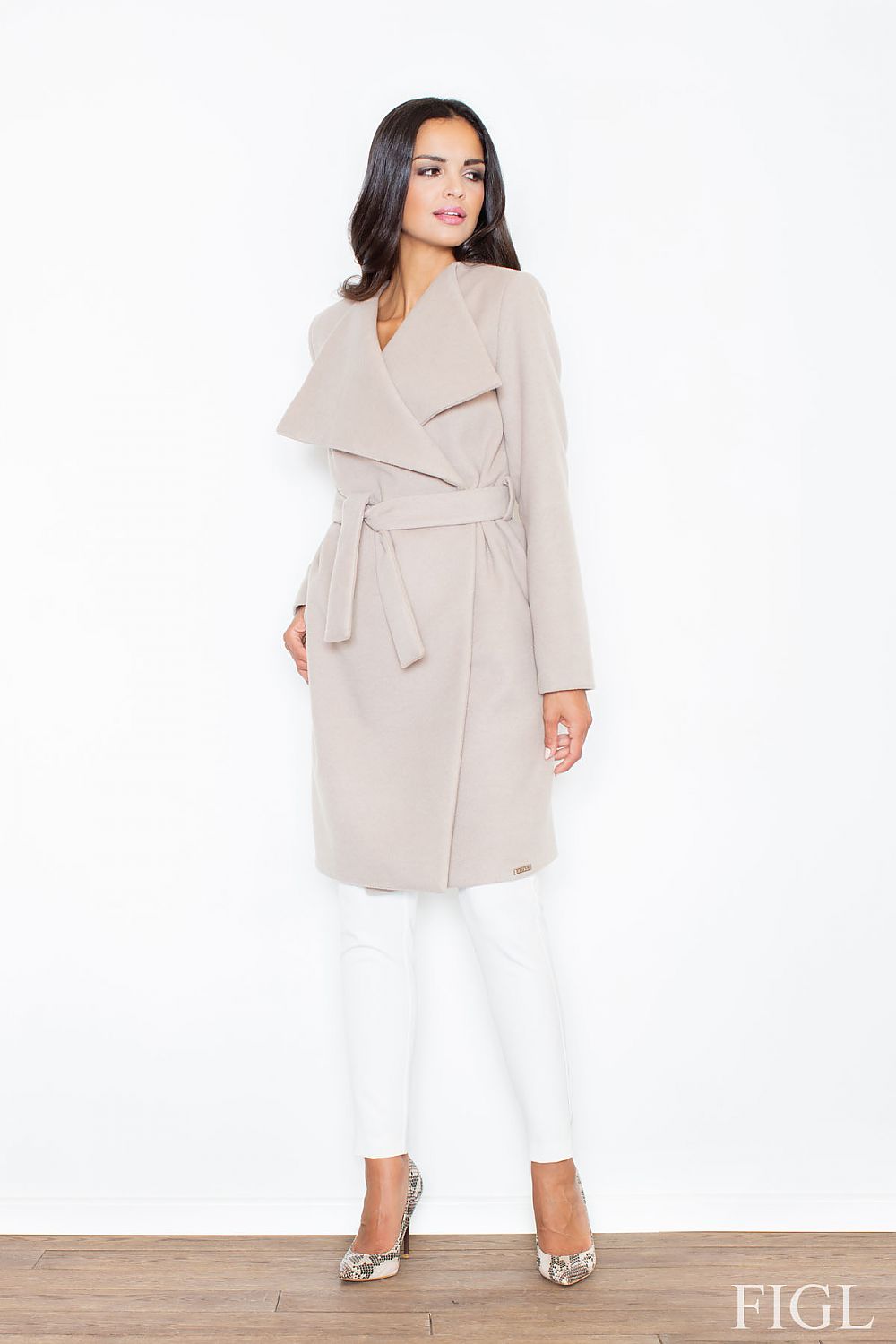 Woman wearing a beige trench coat on a white background