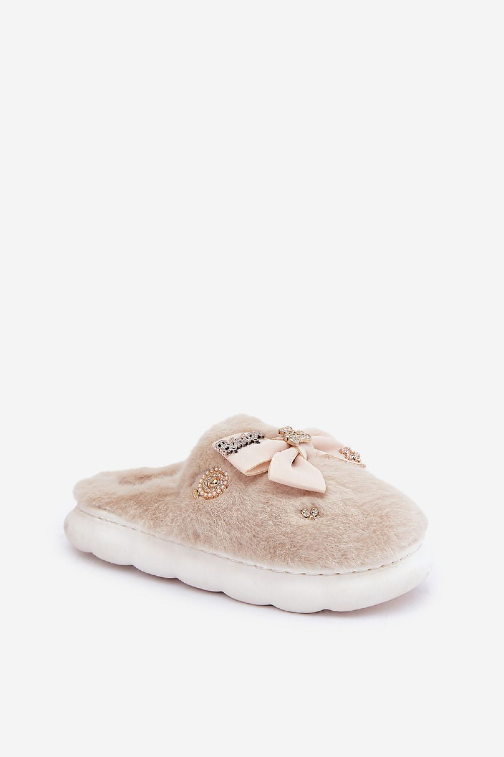 Beige slipper with a bow on a white background