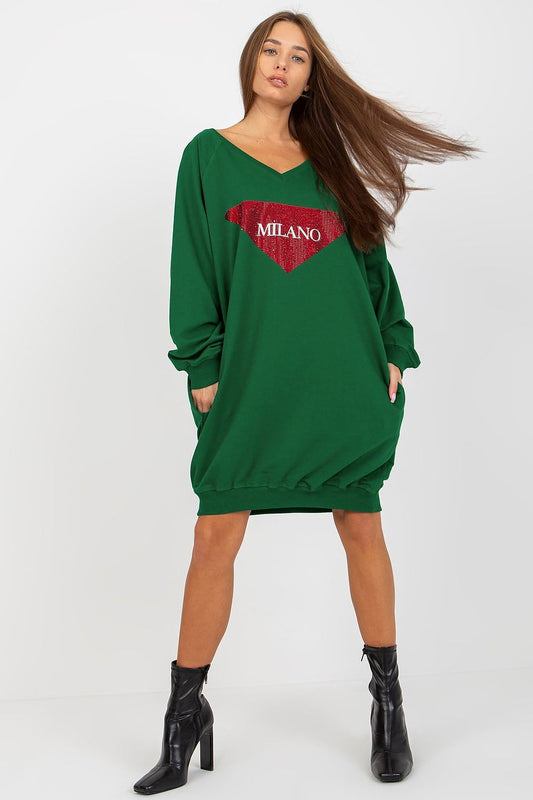 Woman wearing a green sweatshirt dress with 'Milano' print on a white background