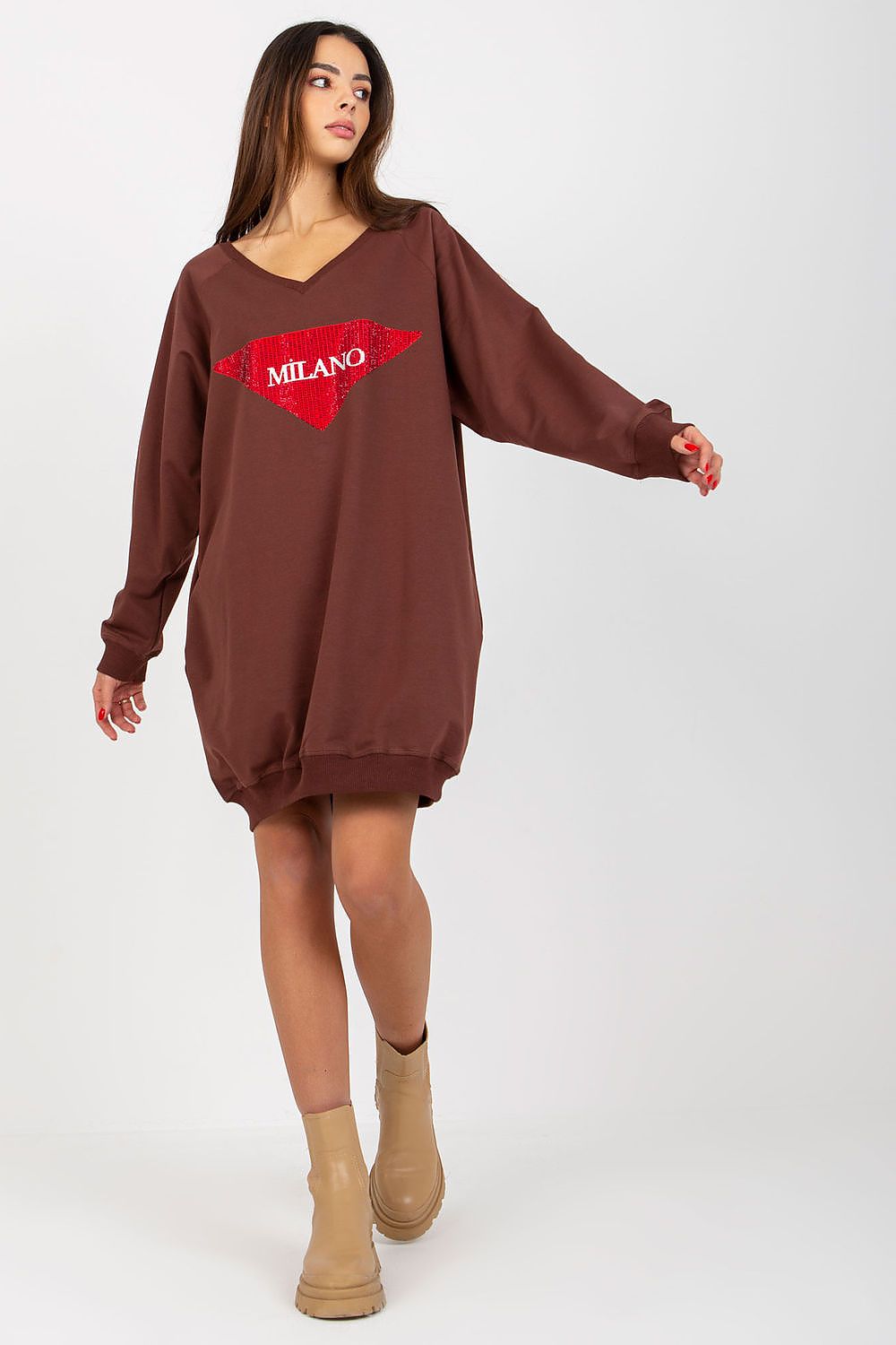 Woman wearing a brown sweatshirt dress with a red logo on a white background