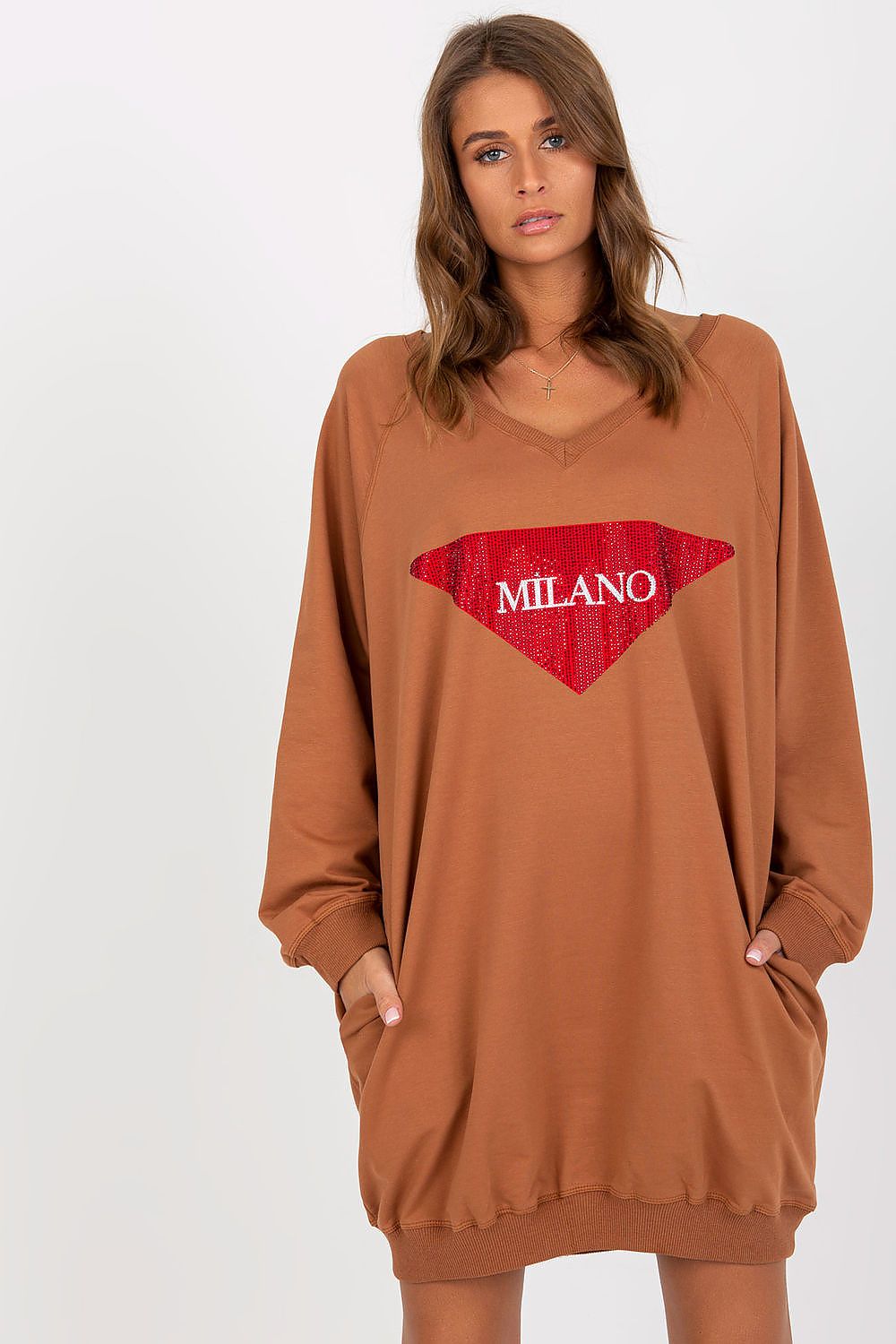 Woman wearing a brown oversized sweatshirt with a red 'MILANO' logo on a white background