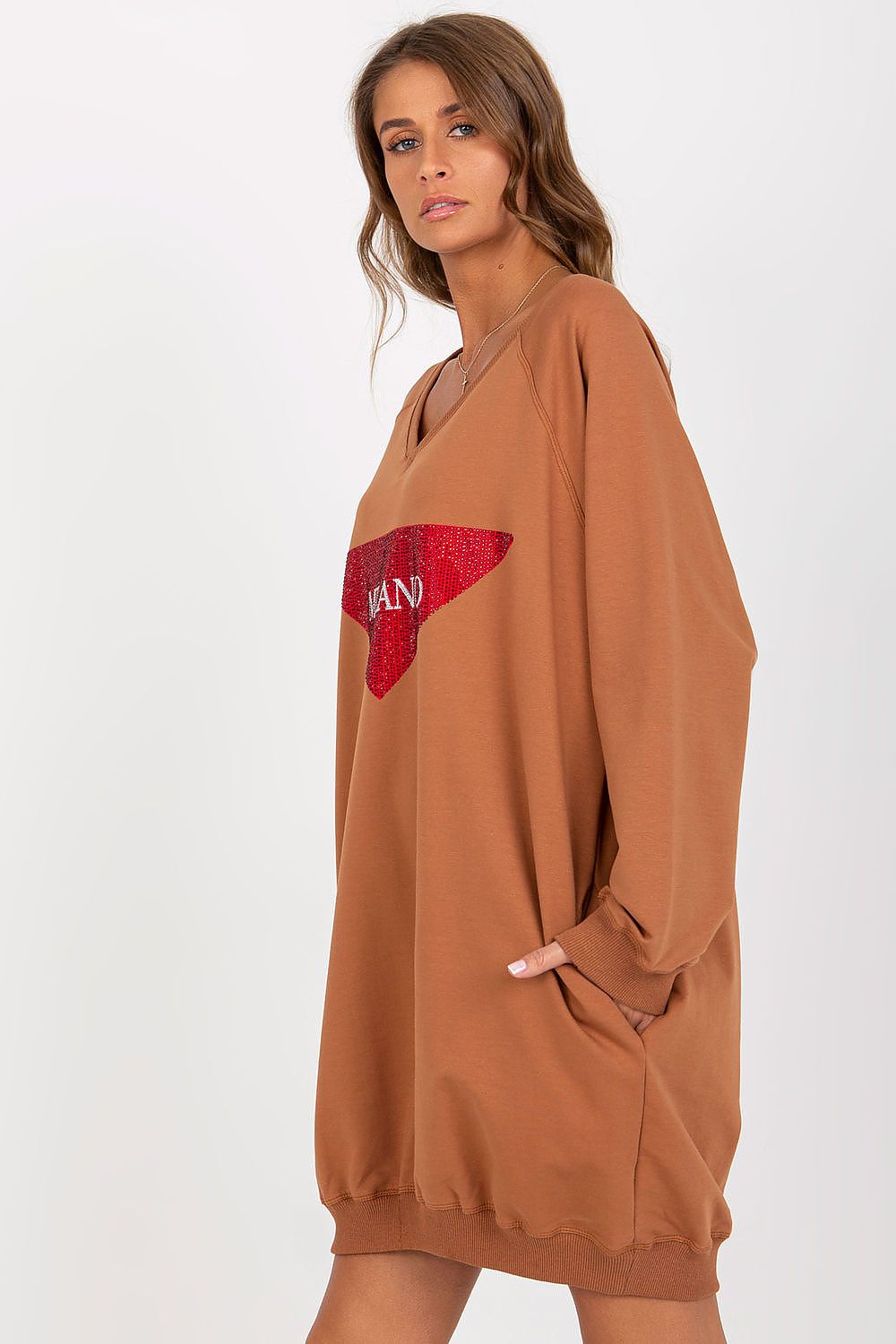 Brown dress with a red heart design on a white background