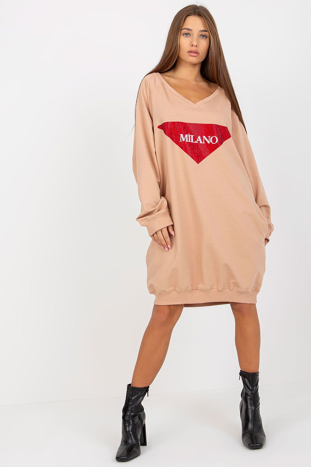 Woman wearing a beige sweatshirt dress with 'Milano' print on a white background