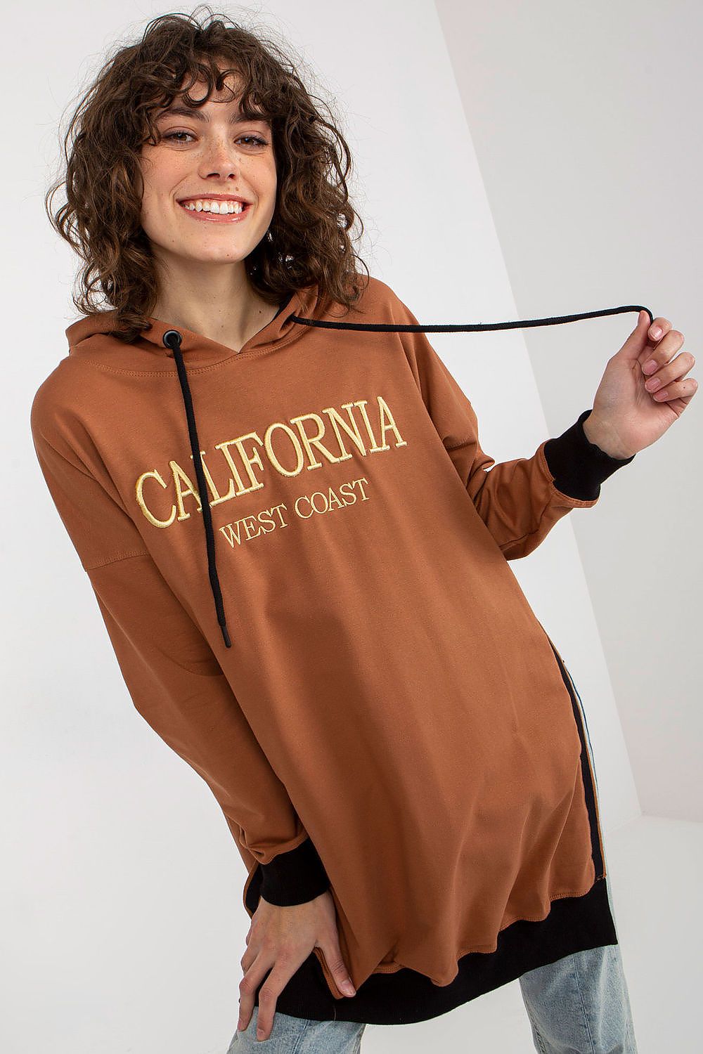 Person wearing a brown hoodie with 'California West Coast' text on a white background