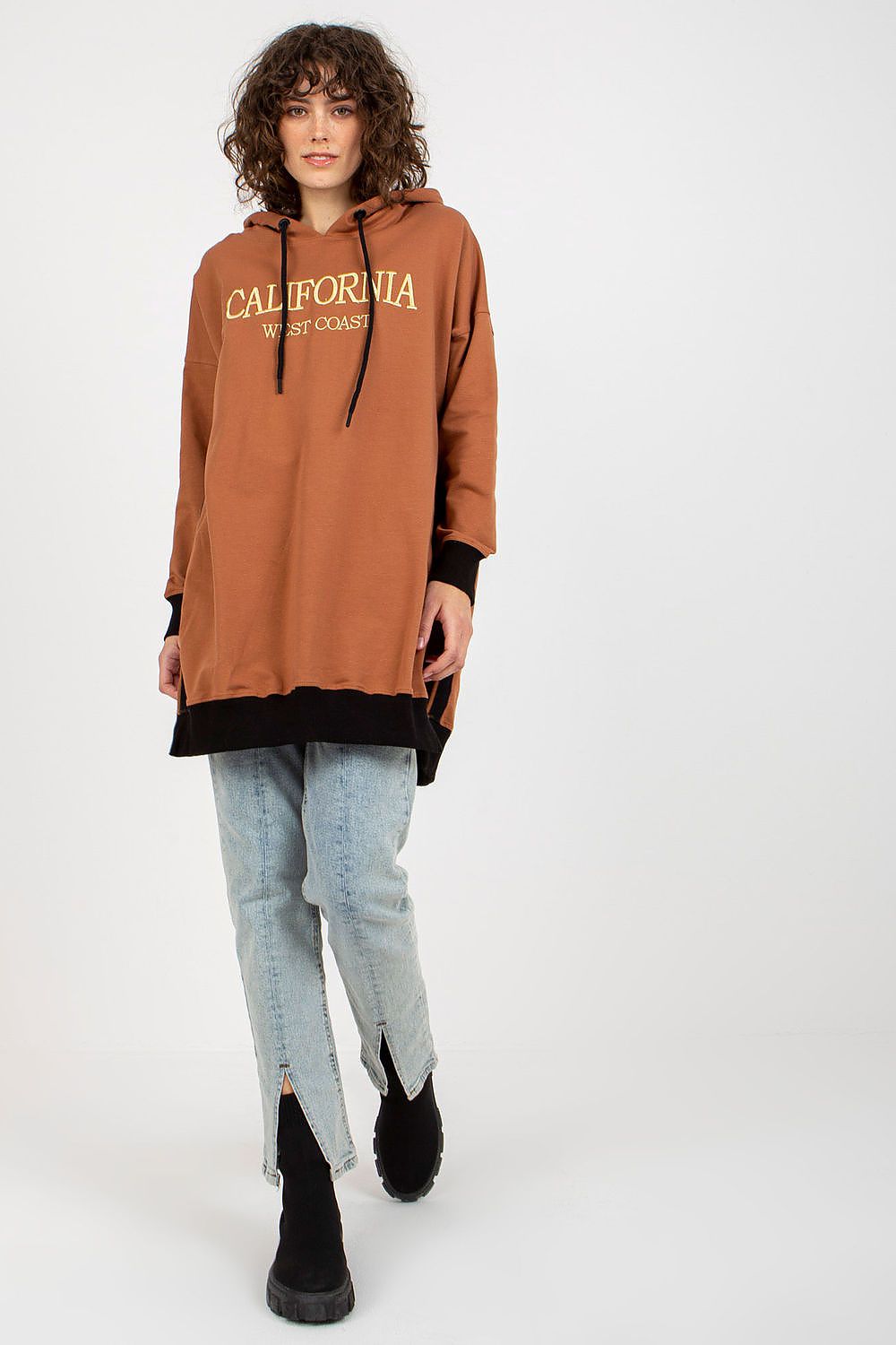 Person wearing a brown hoodie with 'California' text on a white background