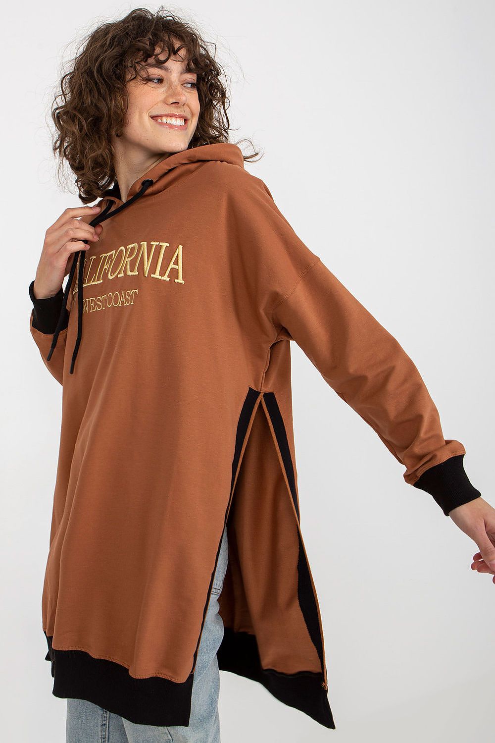 Person wearing a brown hoodie with 'California' text on a white background