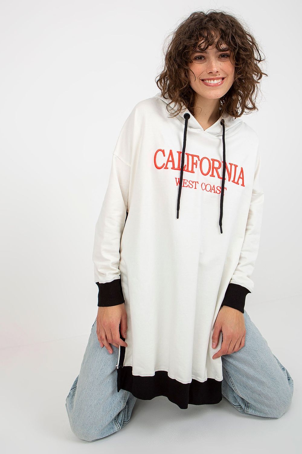Person wearing a white hoodie with 'California West Coast' text on a white background