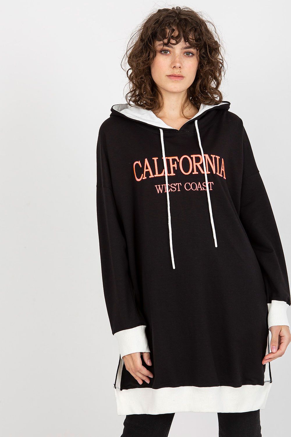 Woman wearing a black hoodie with 'California West Coast' text on a white background