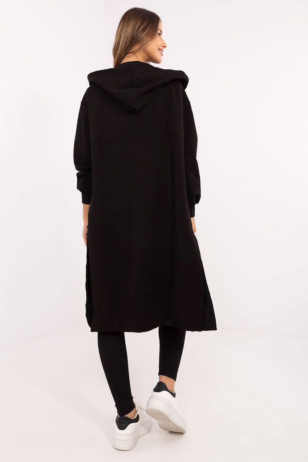 Woman wearing a black hooded coat on a white background