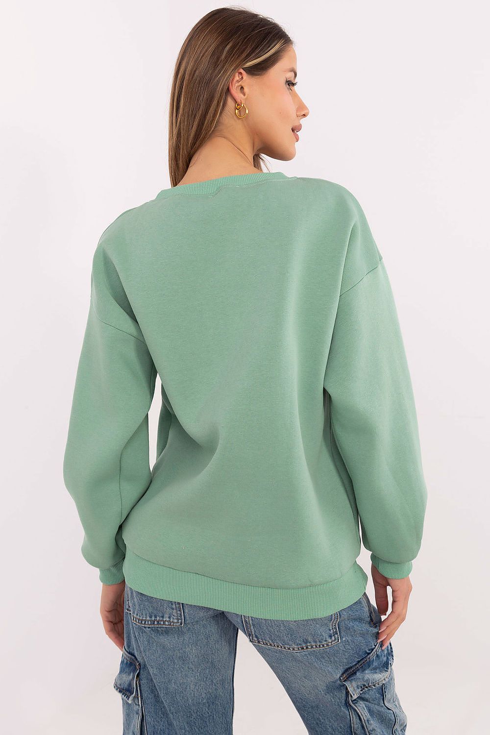  Model wearing green casual sweatshirt with print design.