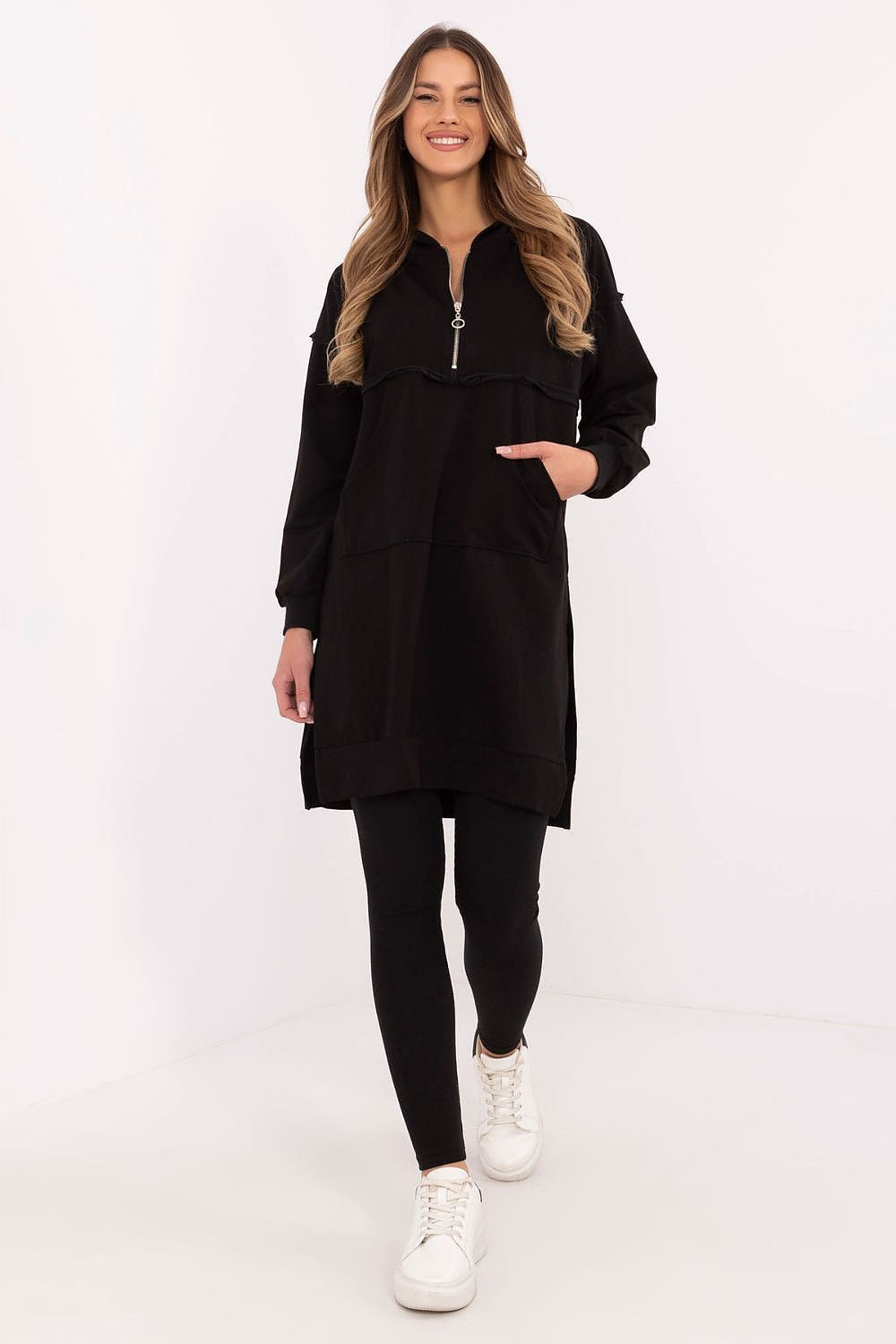 Woman wearing a black dress with a zipper on a white background