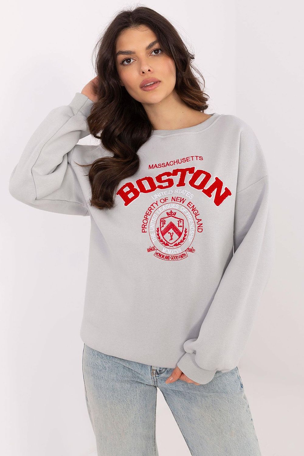 Woman wearing a gray sweatshirt with 'Boston' and 'Massachusetts' text on a white background