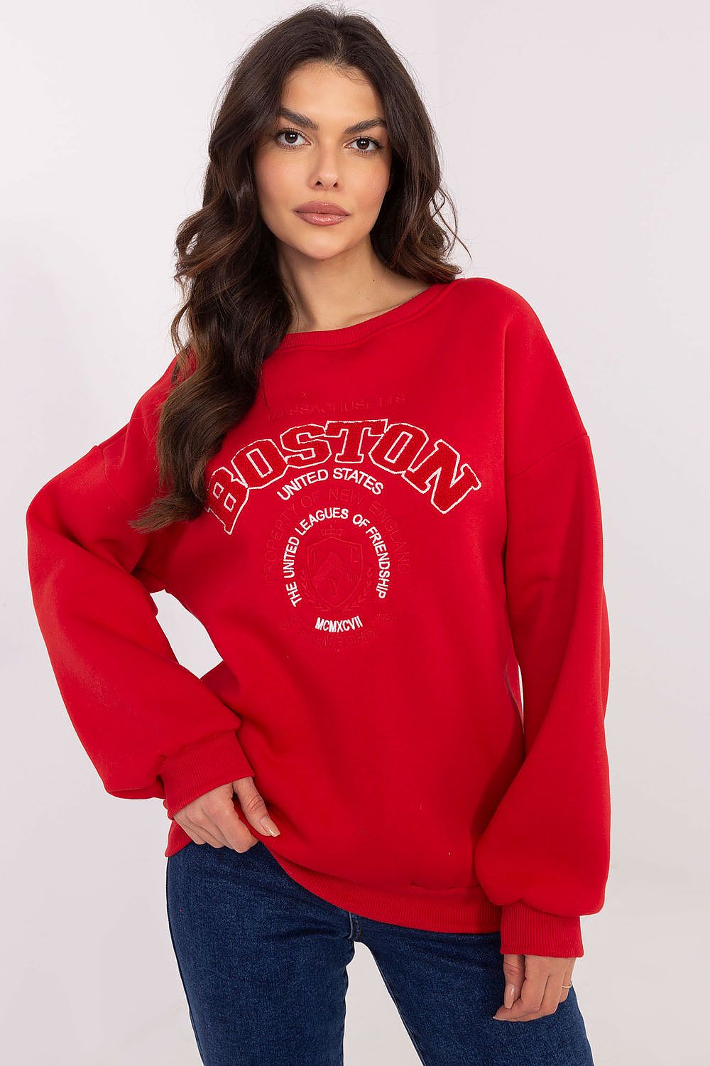 Woman wearing a red sweatshirt with 'Boston' text on a white background
