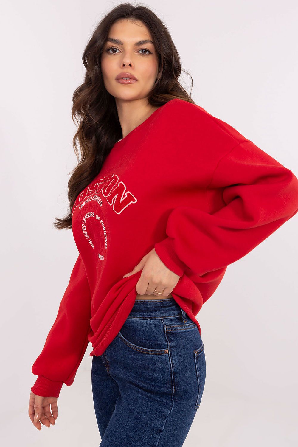 Woman wearing a red sweatshirt with text on a white background