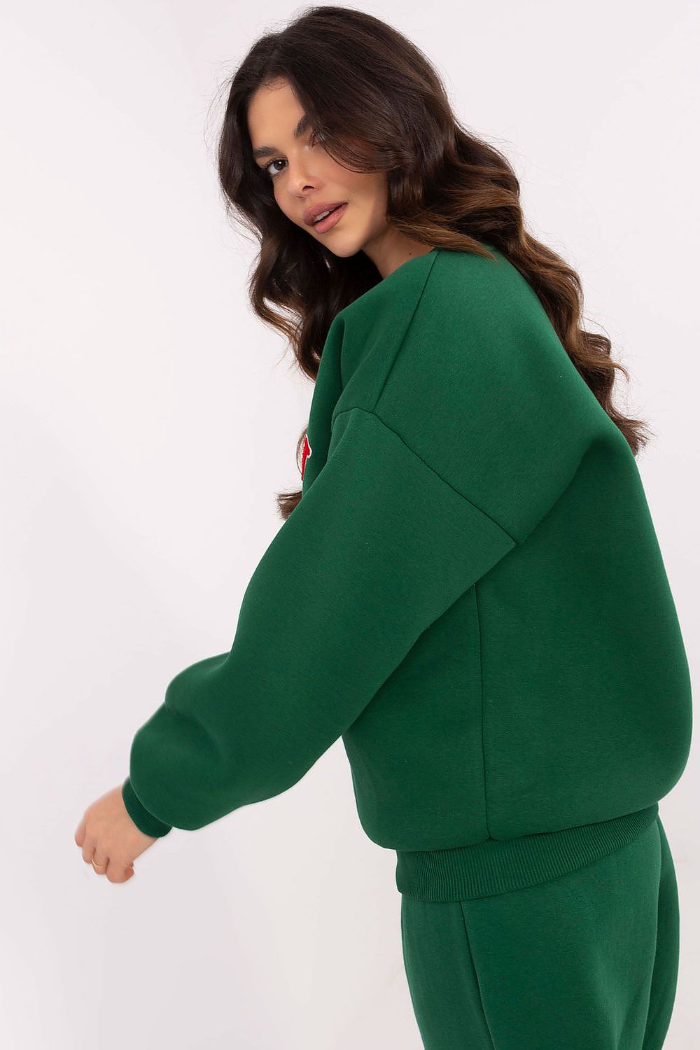 Woman wearing a green tracksuit on a white background
