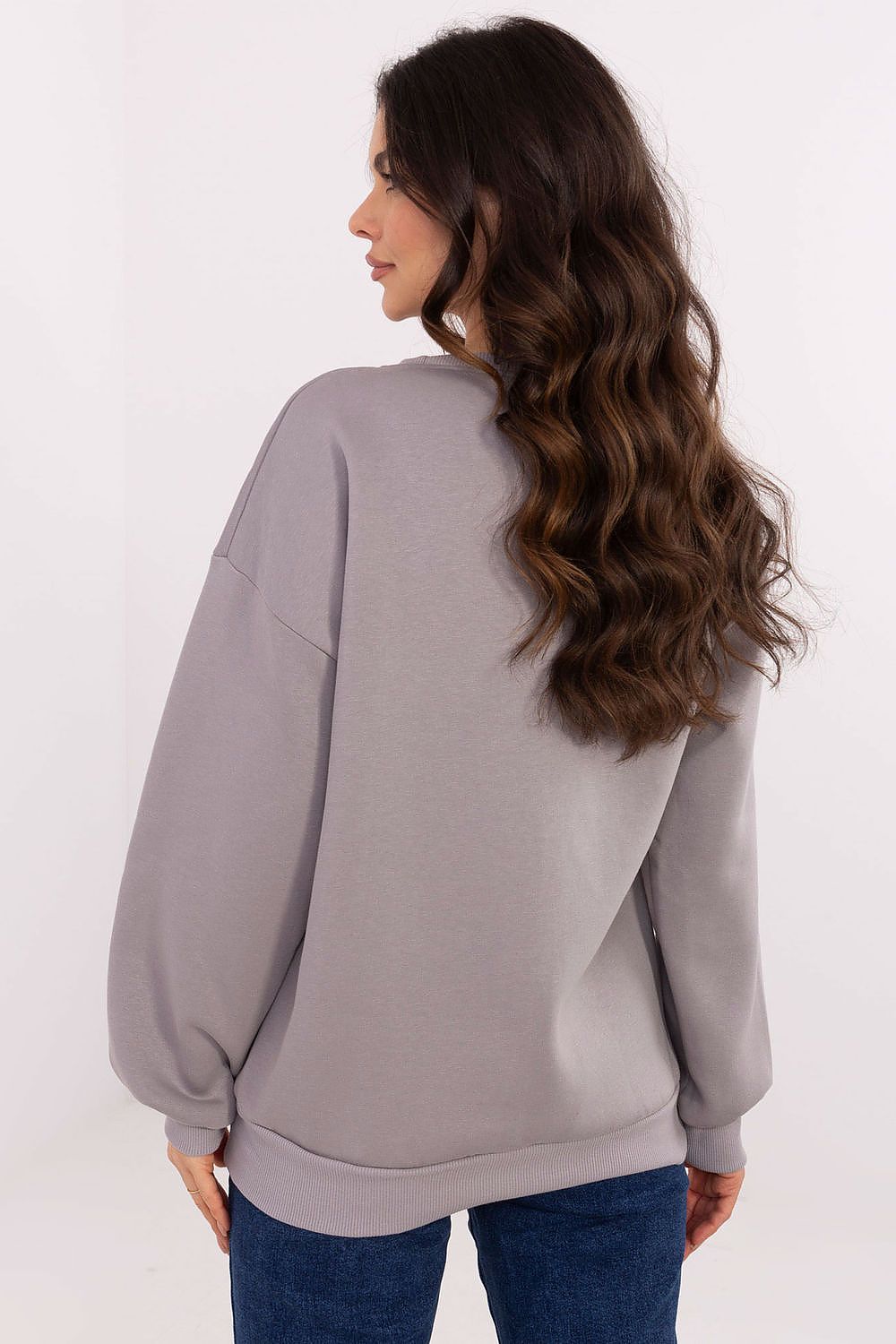 Woman wearing a gray sweatshirt on a white background