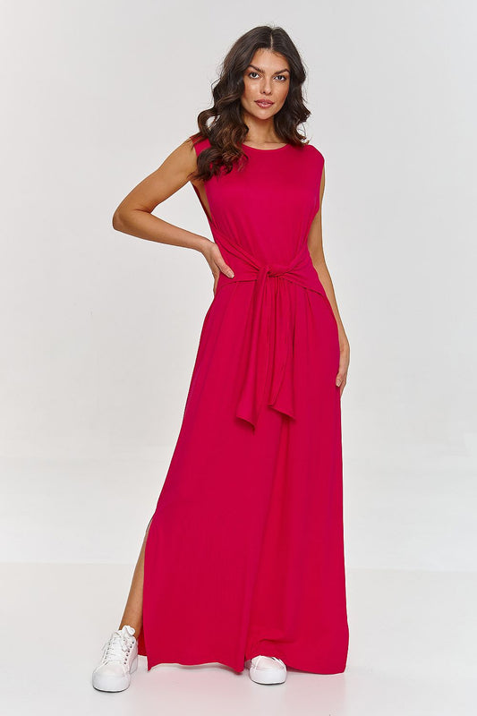 Woman wearing a bright pink dress with a belt on a white background